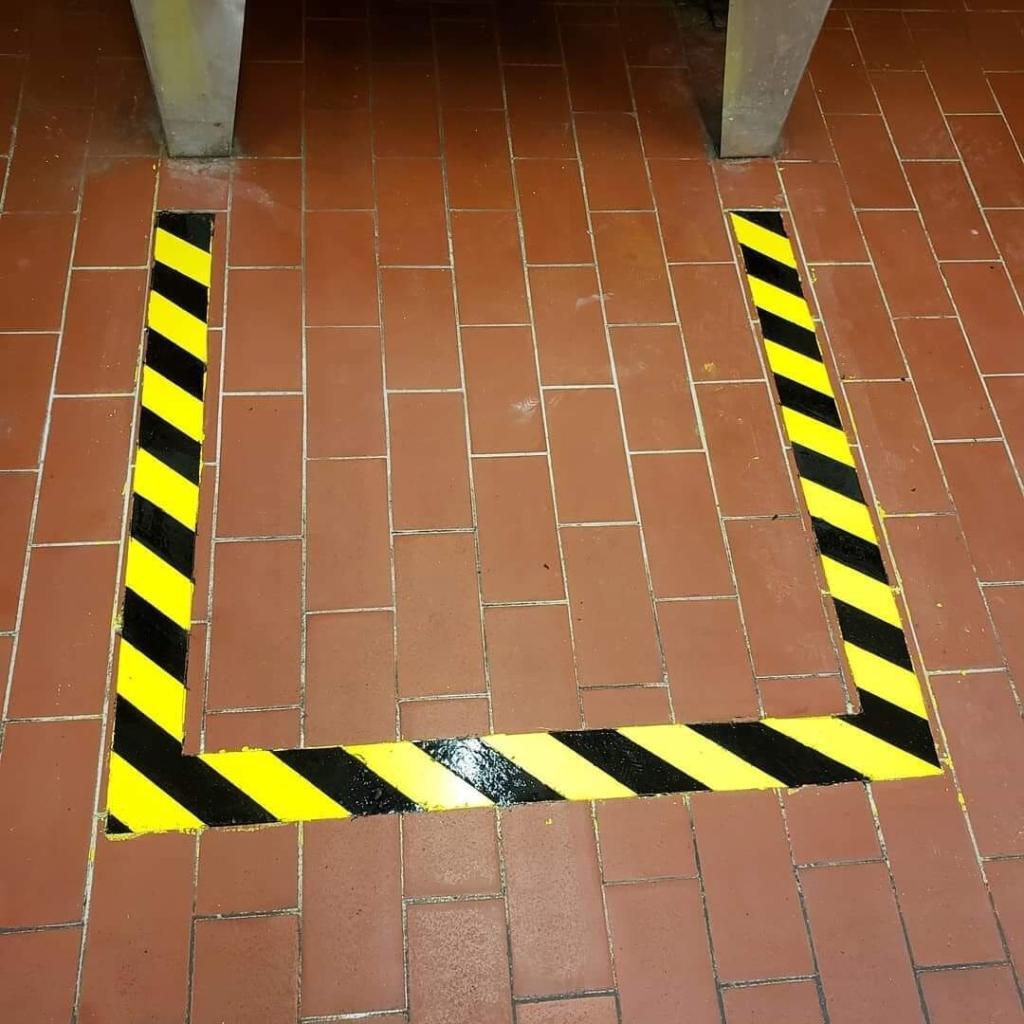 ADA path marking engraved on sidewalk